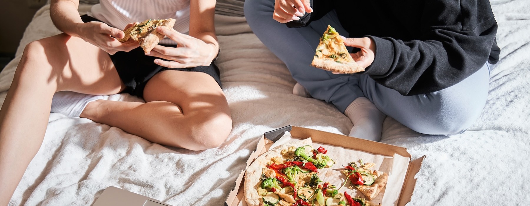 people eating pizza and laptop